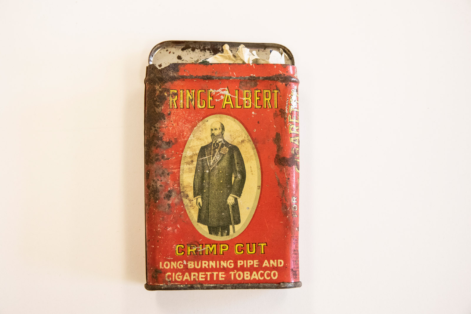 Pictured: One of several tabacco tins containing wrapped up pieces of mirror. Ella Axelrod has spent months investigating, cataloging and digging into the mysteries of a buried box of odd treasures from the late 1800s and early 1900s as a part of their Summer Collaborative Research.