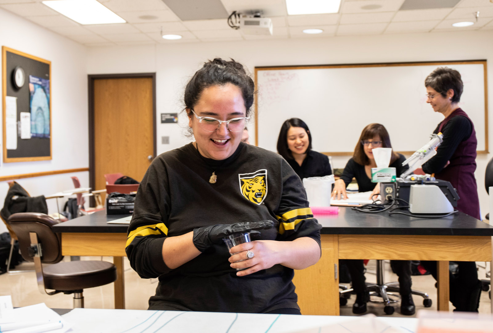 <strong>Kristie Shirley ’20</strong> laughs as she shakes a cup filled with instruments as she tries to find the correct sound making device to go with her team’s aural interpretation of their data.
