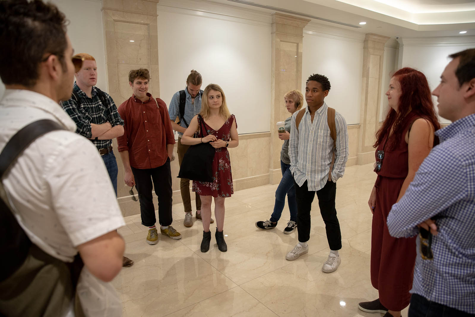Students in the Introduction to Journalism course speak in the lobby of the New York Times office in Washington, DC, following a visit with Thom Shanker on June 20, 2019. Photo by Lydia Thompson.