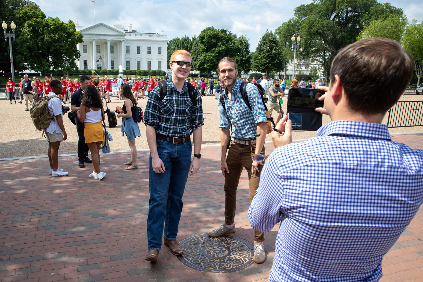 Instructor Corey Hutchins photographs Robert Schilling ’20 (left), and Max Chiaramonte ’20 (right), during an Introduction to Journalism class visit to the White House in Washington, DC, June 20, 2019. Photo by Lydia Thompson.