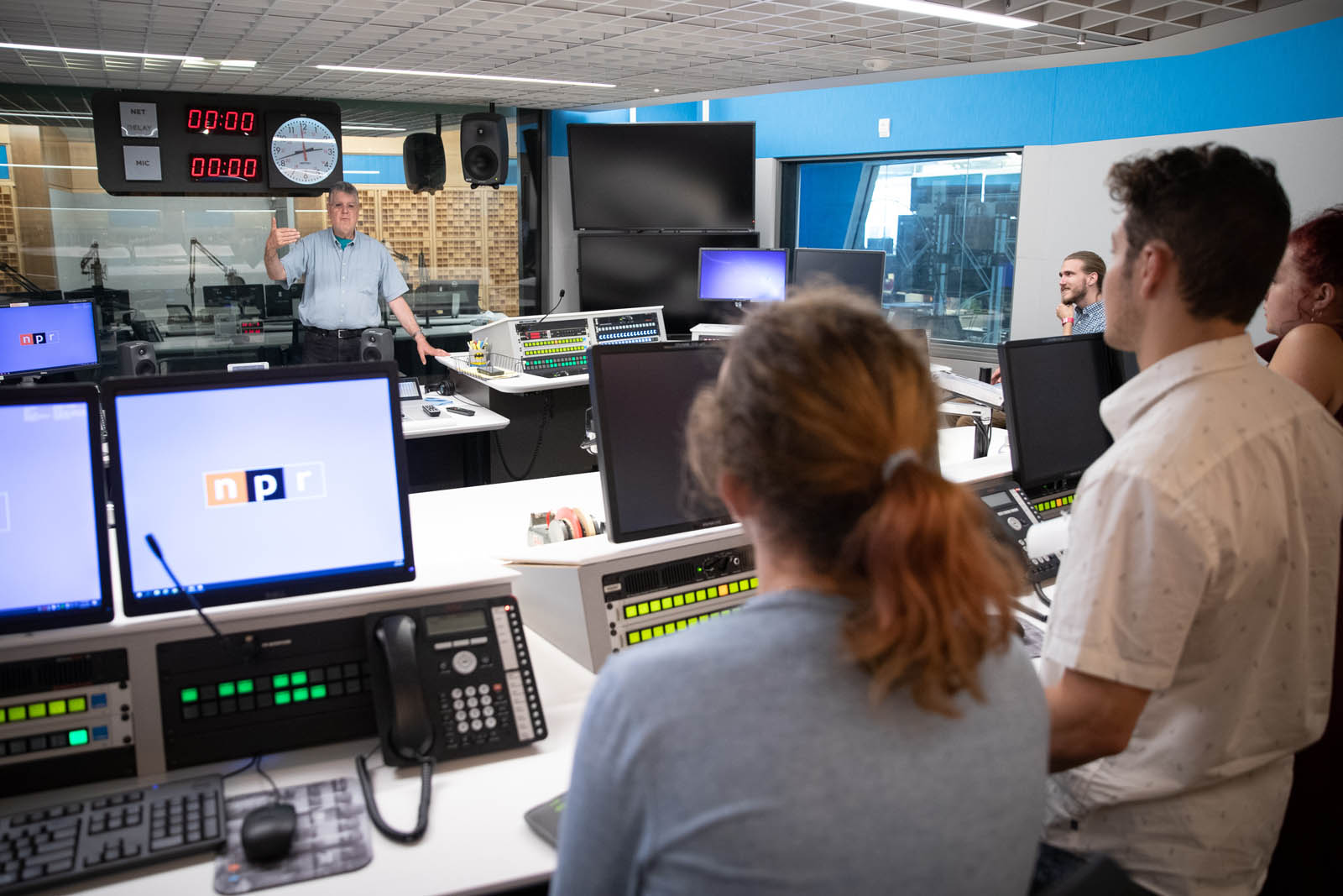 Students in the Introduction to Journalism class receive a tour of a recording studio from NPR Arts Critic Bob Mondello at NPR’s headquarters in Washington, DC, June 20, 2019. Photo by Lydia Thompson.