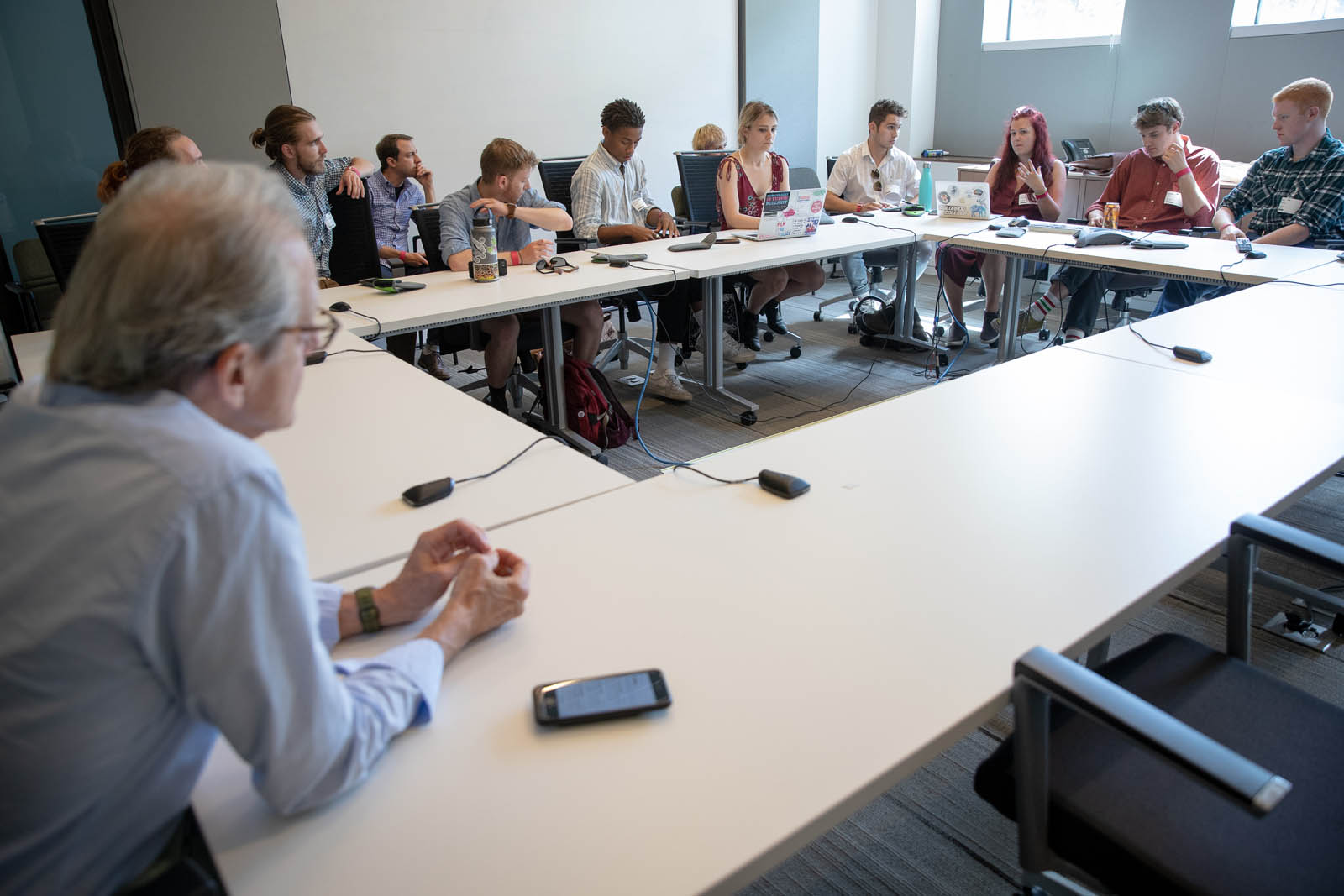 Peter Breslow, senior producer of NPR’s Weekend Edition (far left), listens as students of Introduction to Journalism present their final projects during a class trip to NPR’s headquarters in Washington, DC, June 20, 2019. Photo by Lydia Thompson.