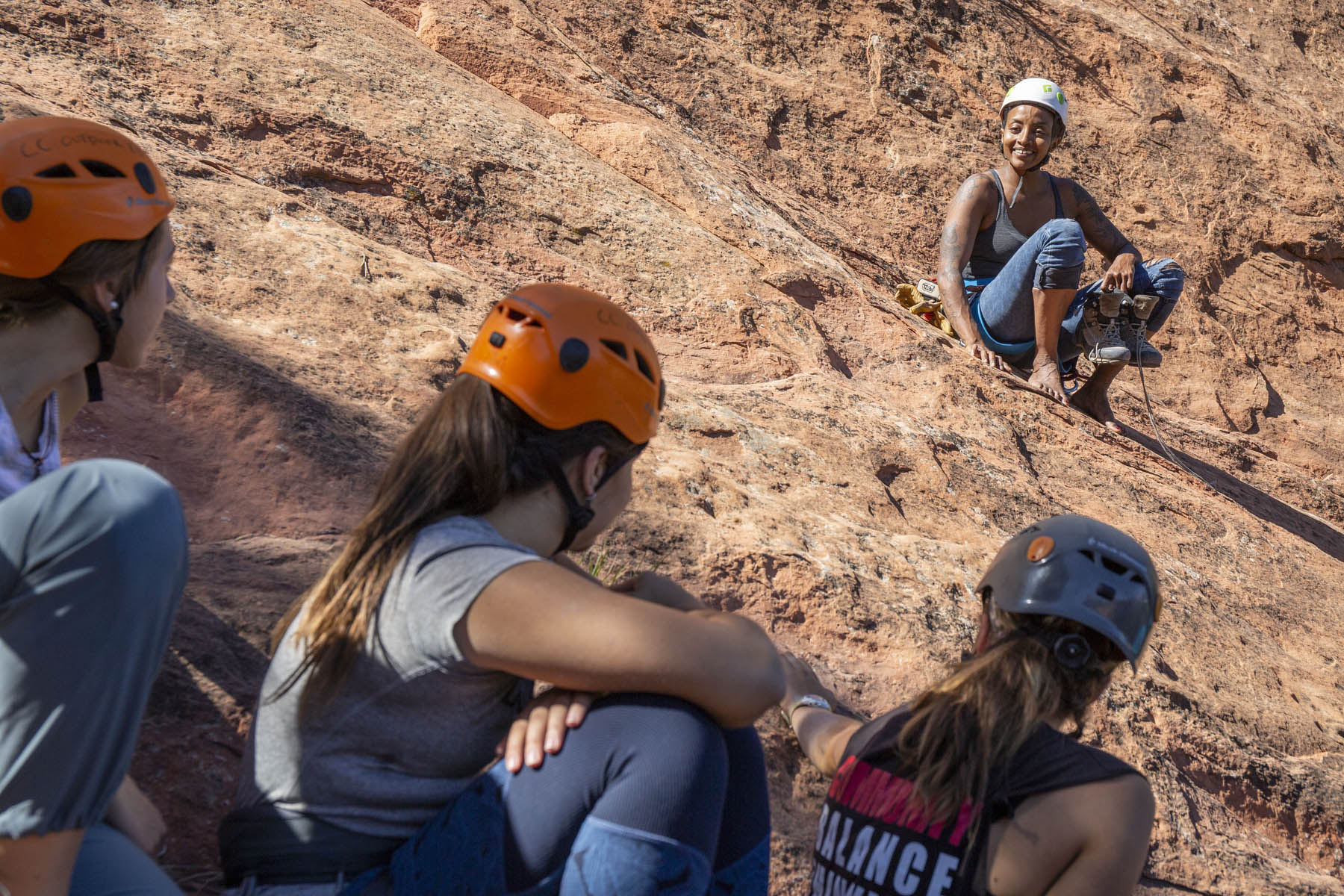 Climber Abby Dione answers questions about her climbing career during an all-female-identifying climbing clinic at Red Rocks Open Space.