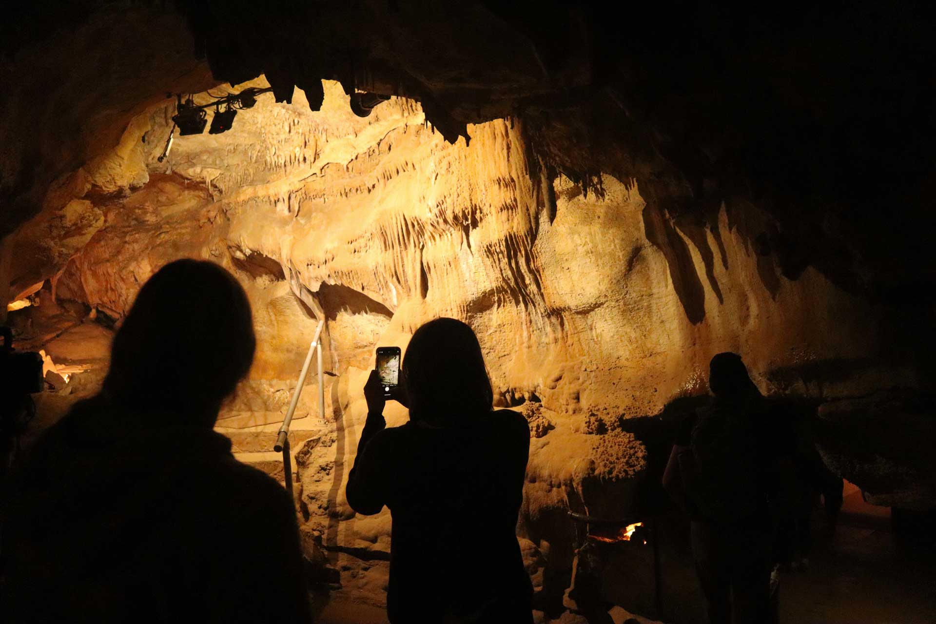 Students take a lantern tour through Cave of the Winds as part of an Outdoor Education trip. Photo by Gracie Roe ’25.