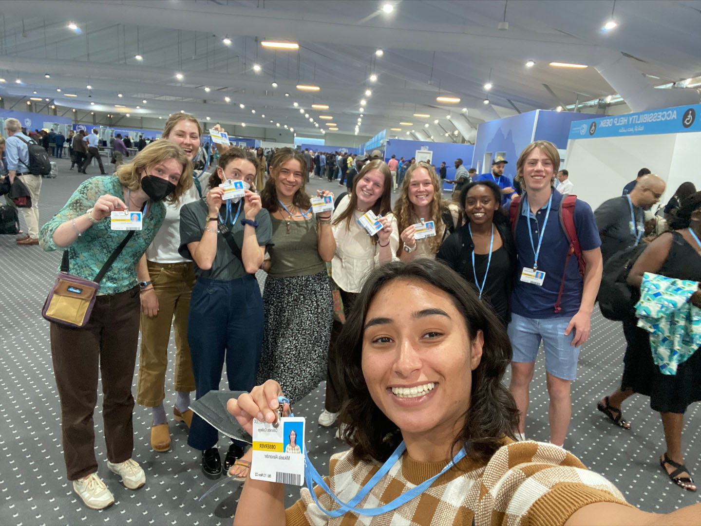Olivia Jacobson '22, Gracie Roe '25, Reeve Schroeder '24, Mary Andrews '23, Mika Alexander '23, Rhetta Power '23, Layla Haji '25, Owen Brown '24, and Naomi Henry '24 are pictured getting their badges at COP 27. Photo taken and submitted by Mika Alexander '23.
