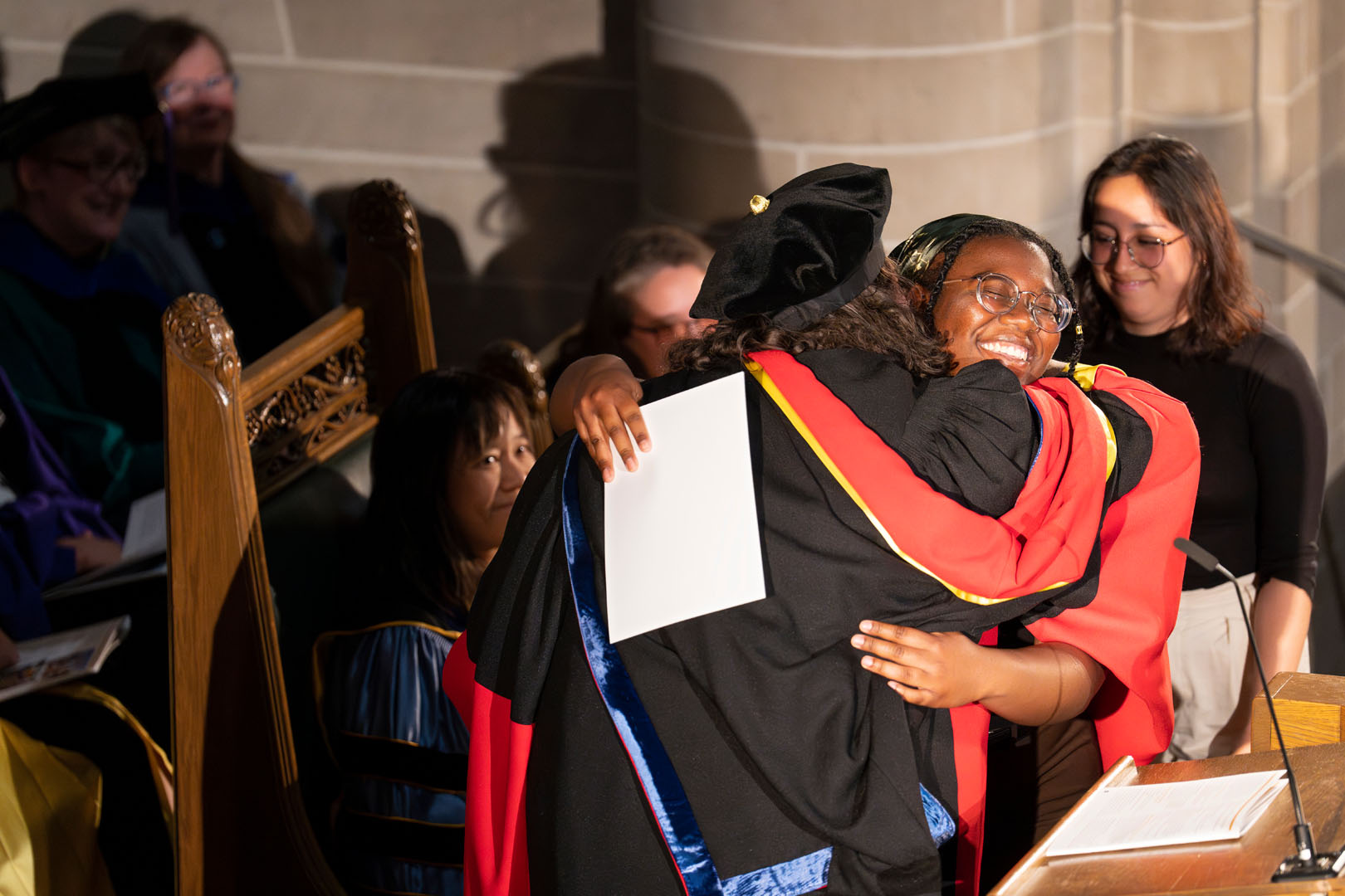 Melanie Barksdale '23 hugs Olivia L. Hatton after receiving the Laboratory Award in Molecular Biology at Honors Convocation on May 16, 2023. Photo by Lonnie Timmons III / Colorado College.