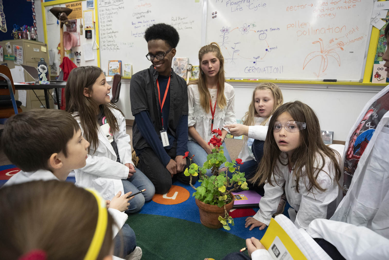<b>Matthew Luzincourt ’21</b> and <b>Ana Nusto ’22</b> work with second-graders to teach them plant science. Photo by Jennifer Coombes.