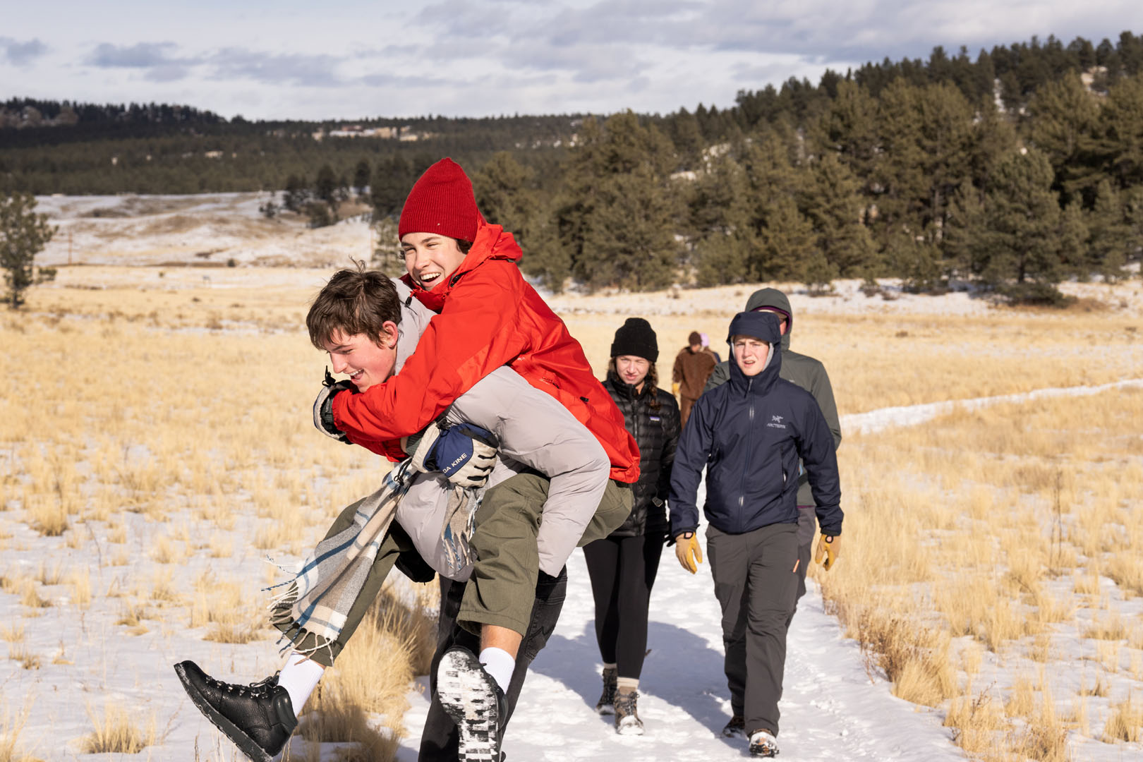 Nate Watson '26 is pictured being carried by Francis Black '26 during their WSO Priddy Experience group exploration of the Florissant Fossil Beds in the Rocky Mountain Southwest on Jan. 27, 2023. Photo by Lonnie Timmons III / Colorado College.