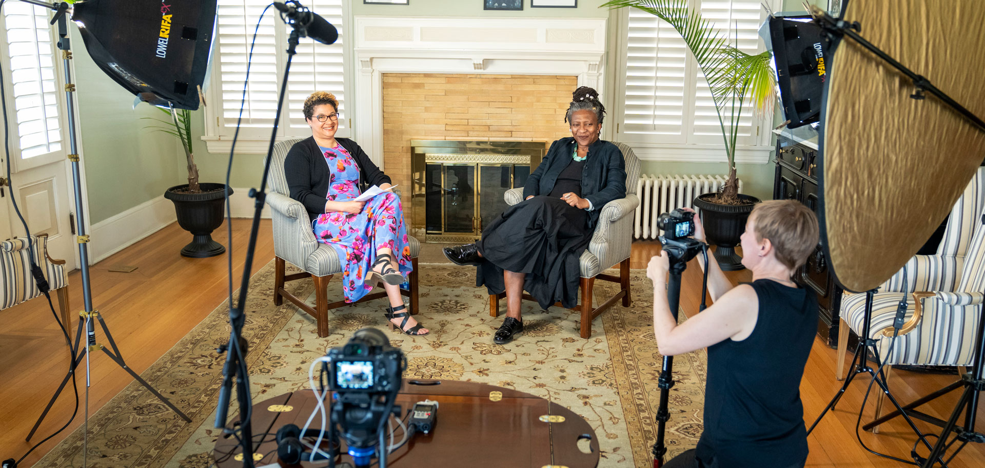 Professor Peony Fhagen and Board of Trustees member Frieda Ekotto on Saturday, April 9, 2022 in Tutt Alumni House about to be filmed by videographer Julia Fuller. Photo by Lonnie Timmons III / Colorado College.