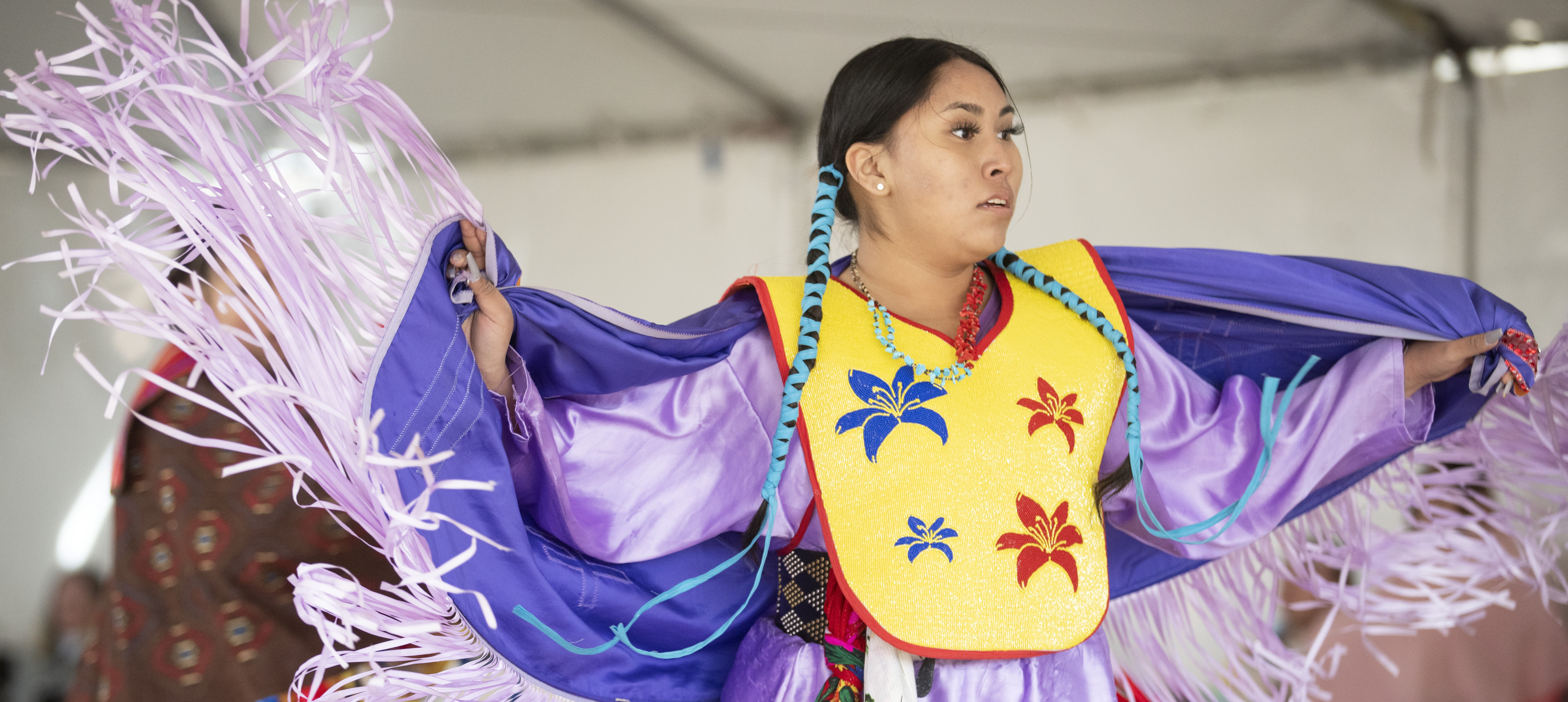 woman in purple traditional dance costume at NASU pow wow