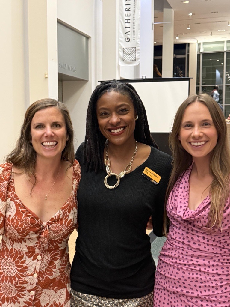 Manya poses with two CC alum
