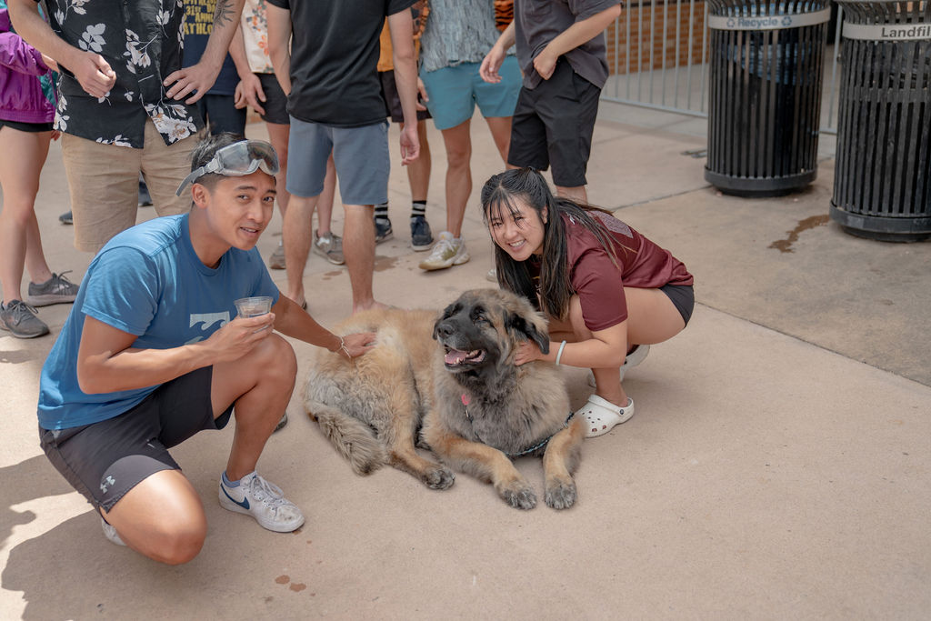Two students and a dog posing for the camera  <span class="cc-gallery-credit">[Gray Filter Photography]</span>