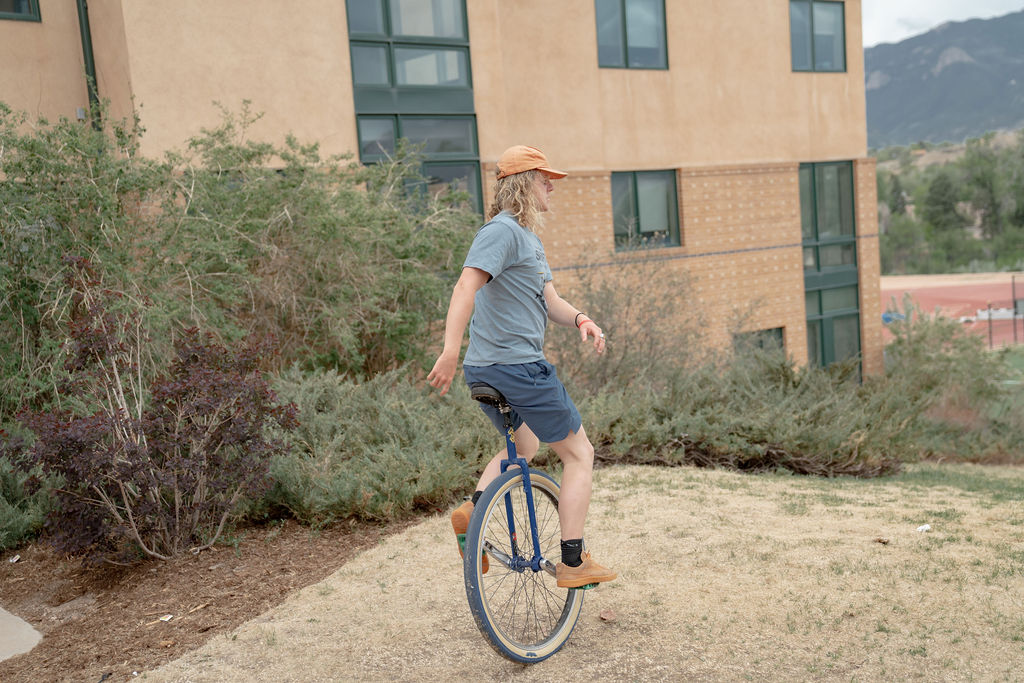 A student on a unicycle on Preserve Hill while attending the senior BBQ <span class="cc-gallery-credit">[Gray Filter Photography]</span>