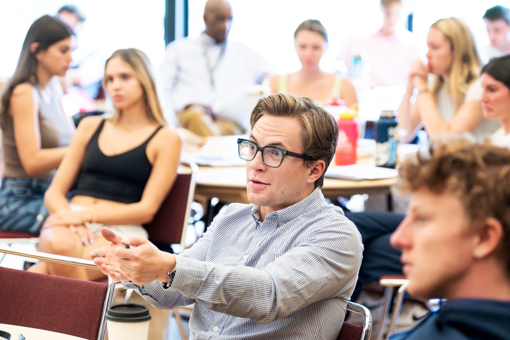 Students discuss ideas during a business class.