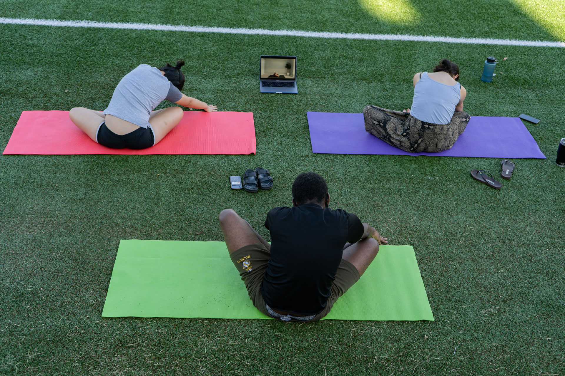 Students exercise outdoors, with masks and social distancing.